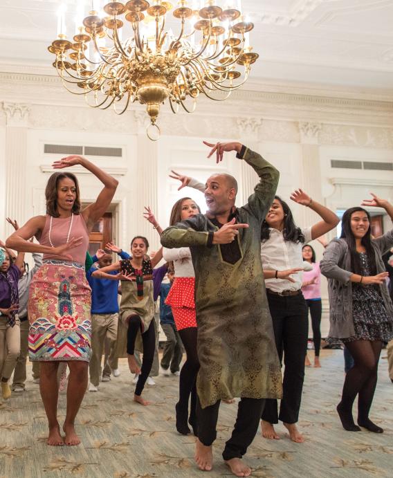 Michelle Obama shows off her moves in a Bollywood dance clinic session, featuring Nakul Mahajan and school students, in the White House's State Dining Room, November 5.