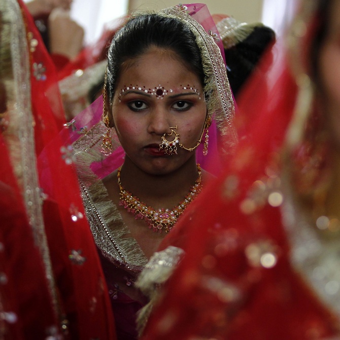 Nandini Krishnan's book explores the dynamics of arranged marriages in today's times. Pictured here are bejewelled brides at a mass marriage ceremony at Noida.