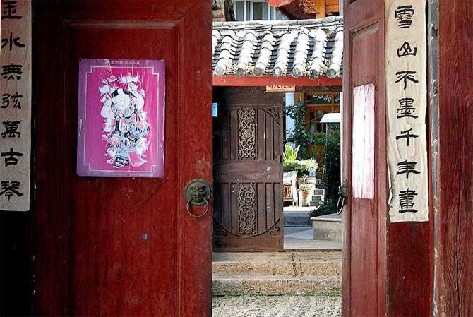 Hand-written Chinese New Year's poetry pasted on the sides of doors leading to people's homes, Old Town, Lijiang, Yunnan, China