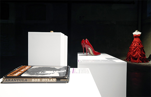 Articles including a book of poetry by Bob Dylan, red high heels and a wedding dress are displayed at the Museum of Broken Relationships.