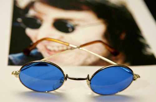John Lennon, born on October 9, 1940, whose sunglasses are seen here alongside his photographs was among the famous people to be born in the year of the Dragon