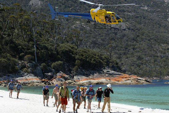 Participants on the beach at Wineglass Bay with the TV helicopter close by, during The Cadbury Schweppes Mark Webber Challenge on November 15, 2003 in Tasmania, Australia.