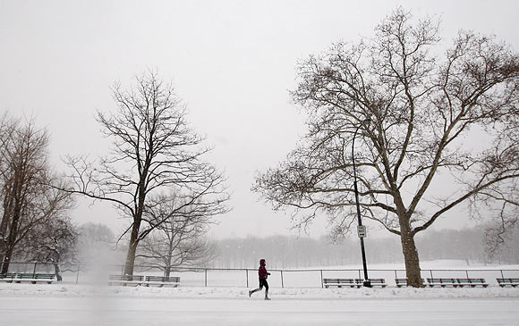 A woman jogs through the snow in New York's Central Park