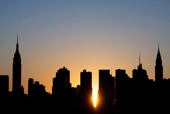 The sun sets over Manhattan aligned exactly with the streets in a phenomenon known as 'Manhattanhenge'