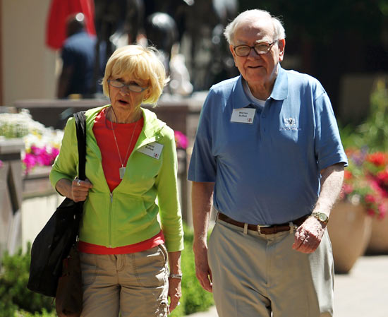Berkshire Hathaway chairman and CEO Warren Buffett (R) and his wife Astrid Buffet walk to lunch during a break on the first day of the Allen and Company Sun Valley Conference in Sun Valley, Idaho