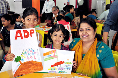 Employees and their families attend a greeting card design workshop
