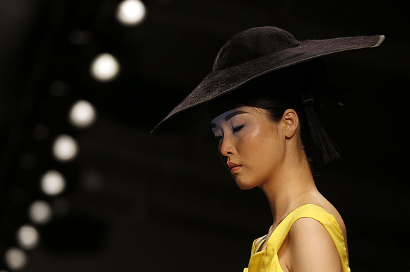 An interesting hat lend another dimension to this canary yellow outfit.