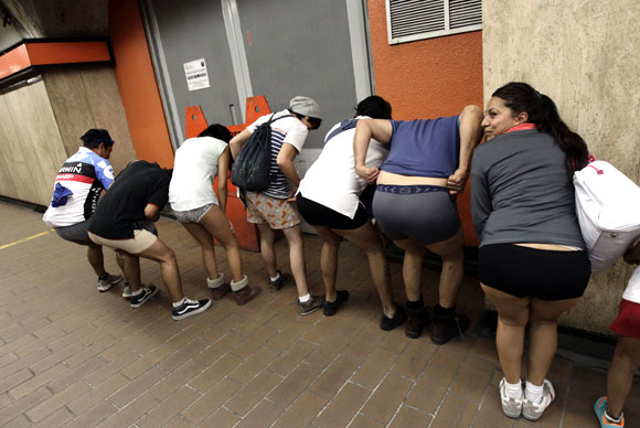 Participants of the No Pants Subway Ride pose for a photo as they wait for the train in Mexico City January 13, 2013