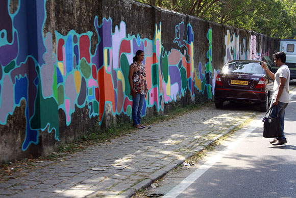 This couple can't resist capturing the street art on their camera