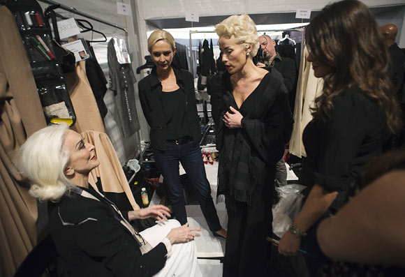 Fashion designer Norisol Ferrari (C) talks with model Carmen Dell'Orefice (L) prior to the presentation of her Spring/Summer 2013 collection during New York Fashion Week September 10, 2012. The collection is Ferrari's first runway show.