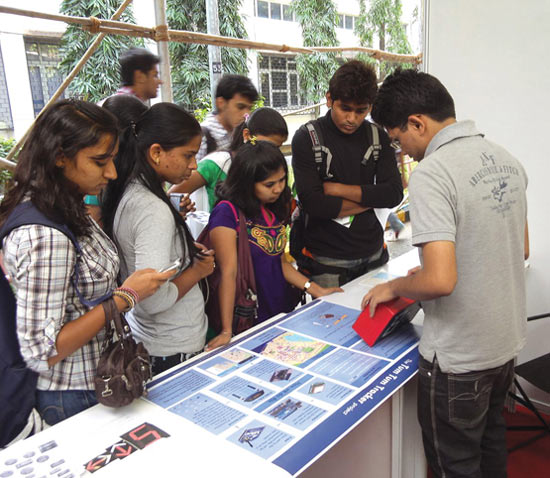 An engineer explains the Tum Tum Tracker app's features to students