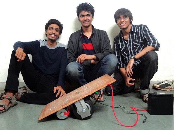 The self balancing skateboard's founders pose with their innovation