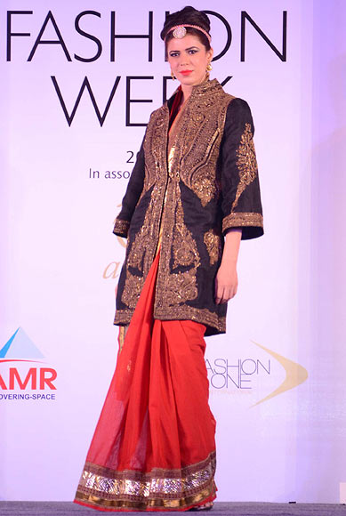 Sucheta Sharma walks the ramp for Raghavendra Rathore at the Aamby Valley India Bridal Fashion Week Preview in Delhi on July 10, 2013