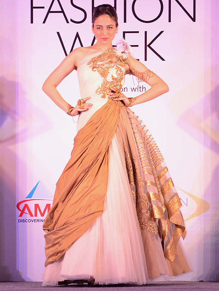 A model walks the ramp for Shantanu & Nikhil at the Aamby Valley India Bridal Fashion Week Preview in Delhi on July 10, 2013