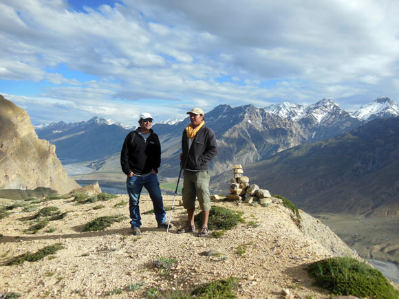 Sushil Dorje, right, has been involved in snow leopard research since 1996. Behind him is a camera-trap spot