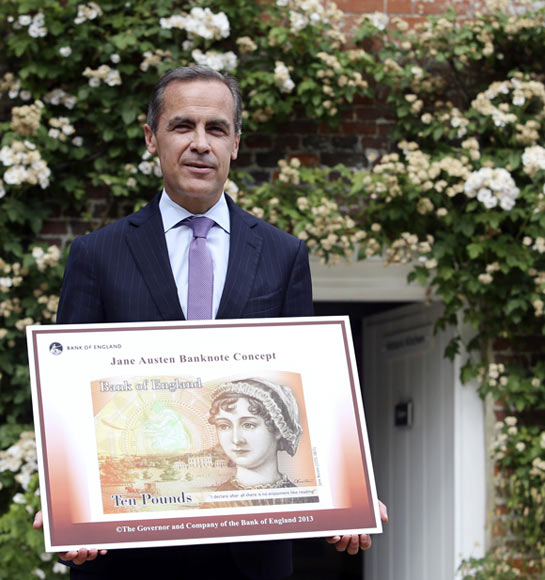 The Governor of the Bank of England, Mark Carney, poses for a photograph with the concept design for the new Bank of England ten pound banknote, featuring author Jane Austen, outside the Jane Austen House Museum in Chawton, southern England. British 19th century novelist Jane Austen will become the face of the new 10 pound note, the Bank of England said on Wednesday, defusing criticism that women are under-represented on the country's currency.