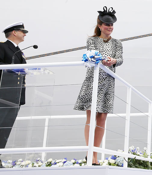 Captain Tony Draper (L) watches as Catherine, Duchess of Cambridge cuts the ribbon during the Princess Cruises ship naming ceremony at Ocean Terminal on June 13, 2013 in Southampton, England
