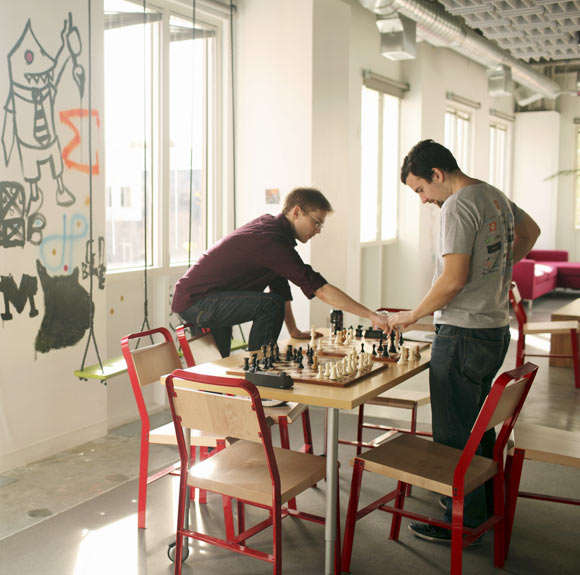 Employees play a game of chess at Facebook headquarters in Menlo Park, California.