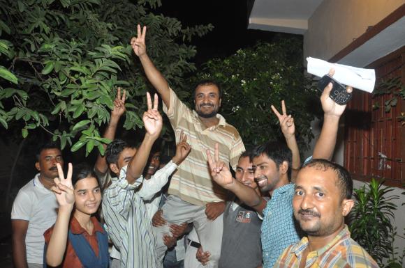 Successful students lift Super 30's Anand Kumar to express their joy on having made it to the IITs