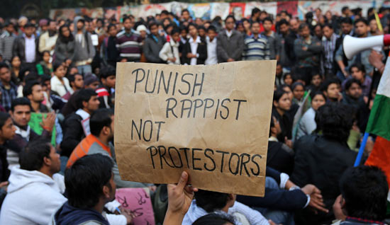 A demonstrator holds a placard during a protest in New Delhi December 24, 2012. Indian authorities throttled movement in the heart of the capital on Monday, shutting roads and railway stations in a bid to restore law and order after police fought pitched battles with protesters enraged by the gang rape of a young woman.