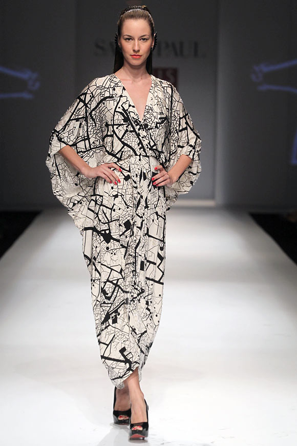 A model walks the ramp for Masaba in a black and white abstract print maxi dress.
