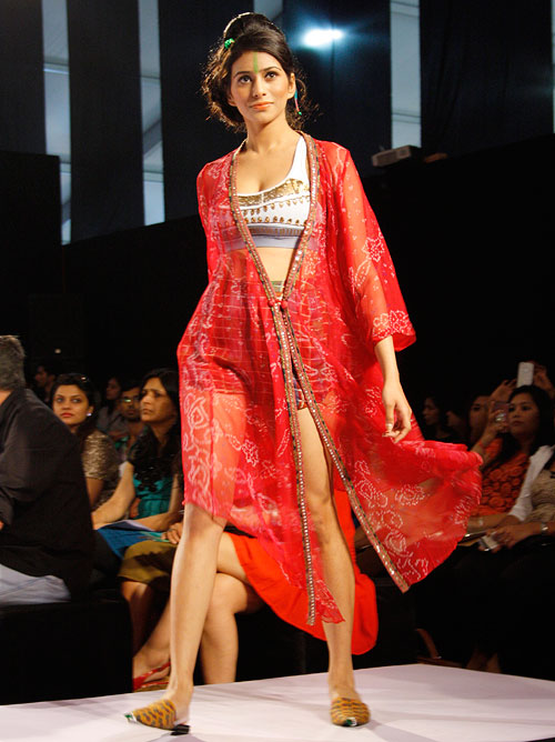 A model shows off a red printed jacket by Anupama Dayal