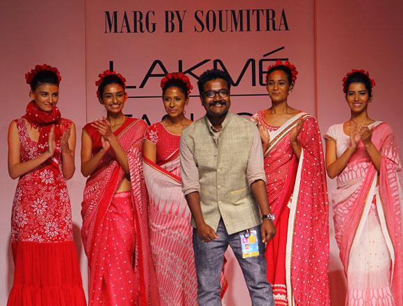 Soumitra Mondol appears on the runway to take a bow as his models and audience break into a round of applause.