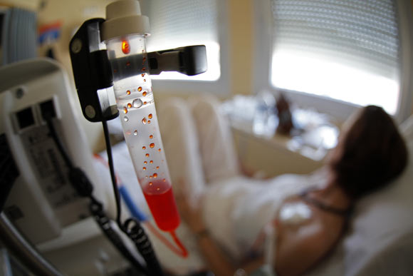 A woman undergoes a mammography exam, a special type of X-ray of the breasts used to detect tumours, as part of a regular cancer prevention medical check-up at a radiology centre.
