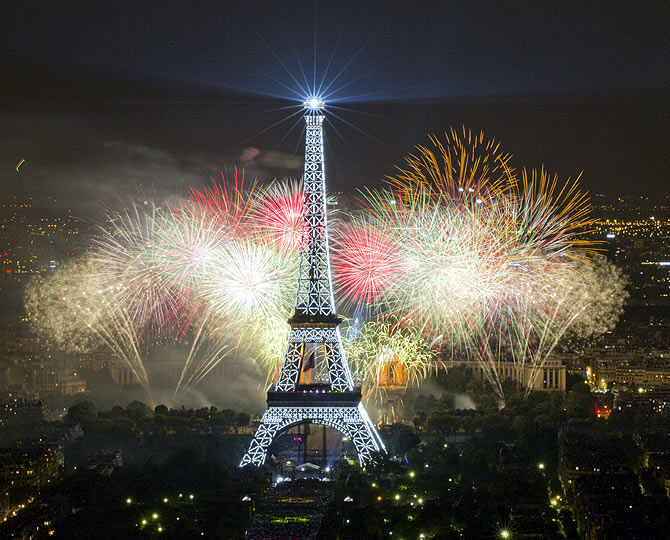 The Eiffel Tower is illuminated during the traditional Bastille Day fireworks display in Paris, France