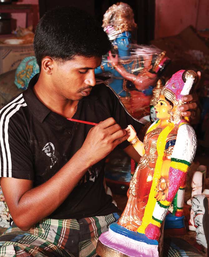 Anwar Basha, a chemistry graduate, runs his family business of making Kolu dolls.