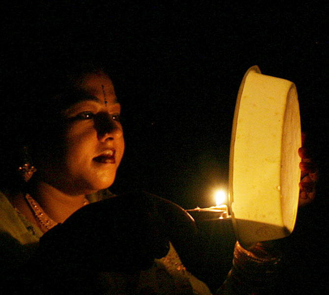 A woman prays during the Hindu festival of Karva Chauth, in the northeastern Indian city of Siliguri 