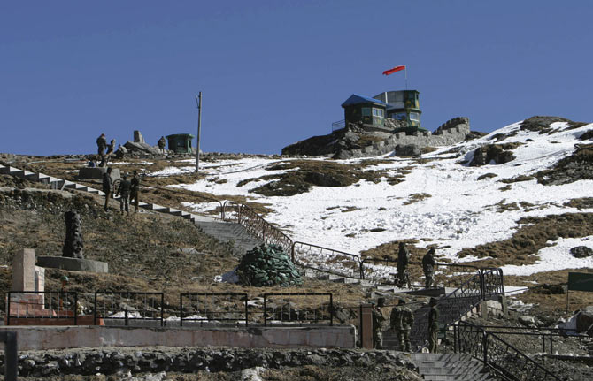 Indian army soldiers are seen after a snowfall at the India-China trade route at Nathu-La, 55 km (34 miles) north of Gangtok. The Nathu-La mountain pass, known as the old Silk Route, lies at an altitude of 14,200 ft. bordering between India and China and is covered with snow throughout the year.