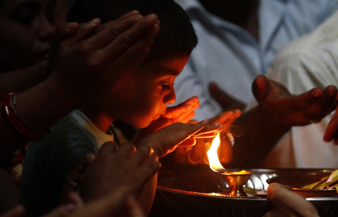 A Hindu boy prays during the festival of Diwali at Shivm Kovi temple in Colombo 