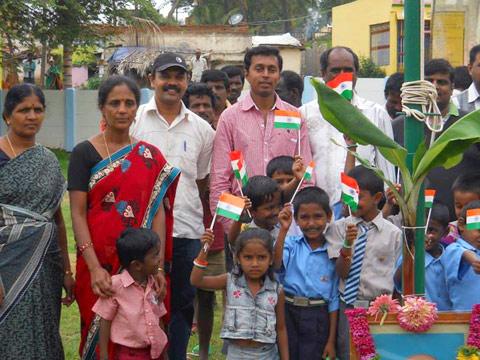 Santosh poses with kids and teachers from a local school in Bangalore