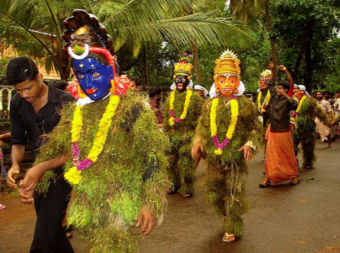 Kummati artists participate in a procession in Thrissur, Kerala