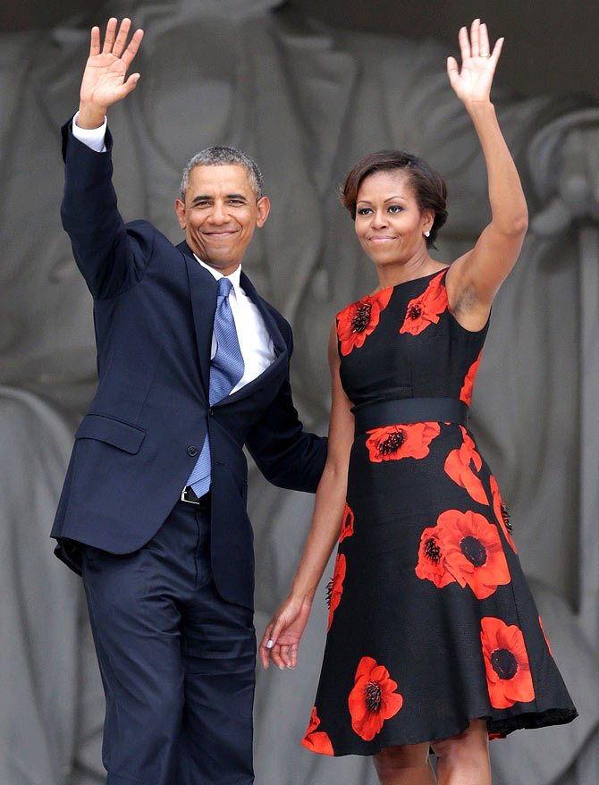 U.S. President Barack Obama (L) and first lady Michelle Obama wave as they leave at the end of the Let Freedom Ring ceremony at the Lincoln Memorial August 28, 2013 in Washington, DC. The event was to commemorate the 50th anniversary of Dr. Martin Luther King Jr.'s I Have a Dream speech and the March on Washington for Jobs and Freedom.