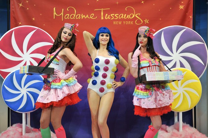 Is this for real? Usherettes pose with a new wax figure of Katy Perry unveiled at Madame Tussauds, New York City.