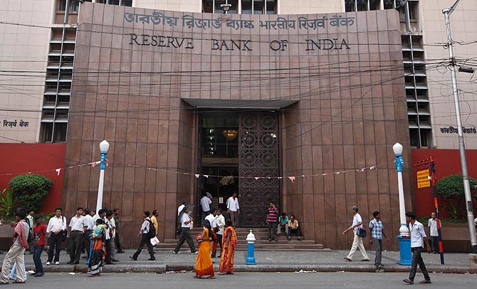 People walk in front of the Reserve Bank of India (RBI) building in Kolkata
