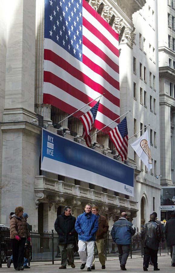 People walk in front of the NYSE