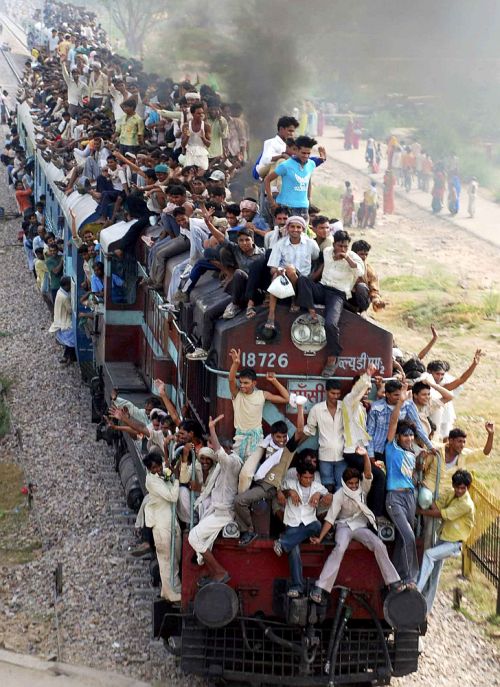 Hindu devotees travel on a crowded passenger train to take part in the 'Guru Purnima'.