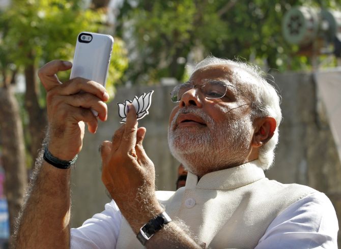 Prime Minister Narendra Modi takes a 'selfie' with a mobile phone after casting his vote.