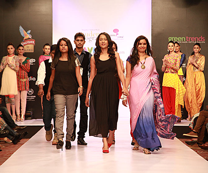 The designers from Dream Zone take to the ramp as the models look on.