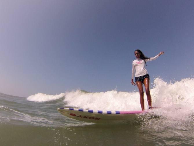 Ishita Malaviya surfing at a beach