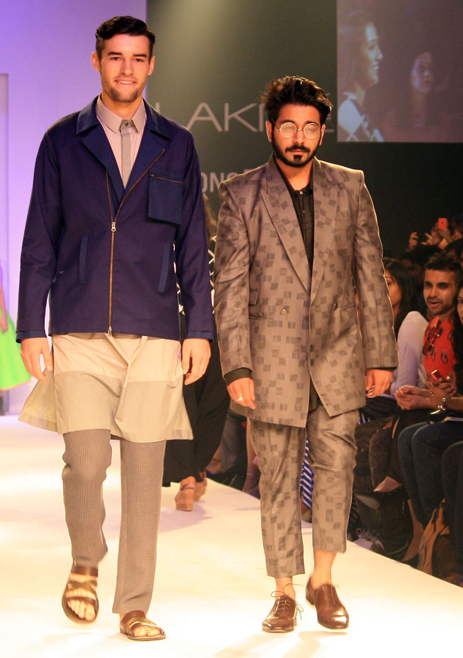 Anuj Bhutani with a model showing the designer's creation.