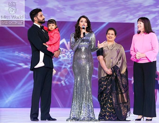 Aishwarya Rai Bachchan -- who was felicitated for being the most successful Miss World at the 2014 pageant -- with husband Abhishek Bachchan, daughter Aaradhya, mother Vrinda Rai and Miss World organiser Julia Morley in London. Photograph: Kind courtesy, missworld.com