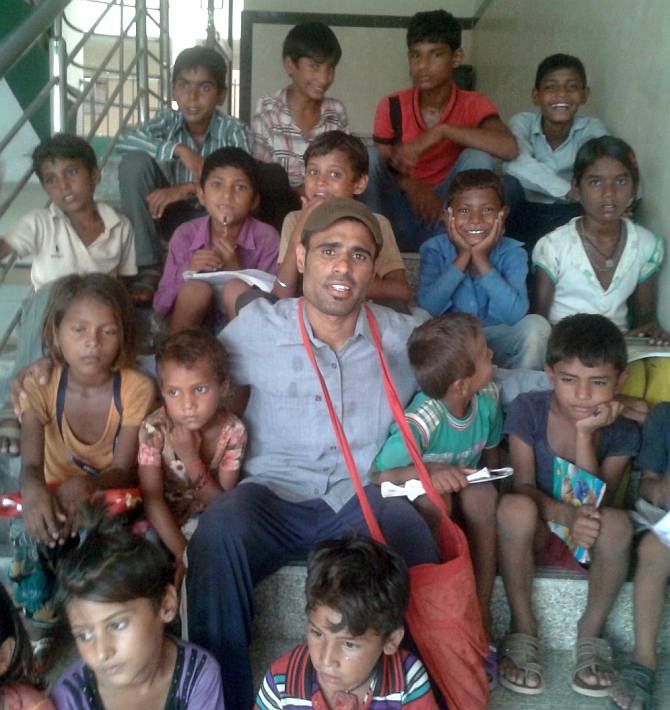 Om Prakash Gurjar with the children of migrant labourer's for whom he runs a school