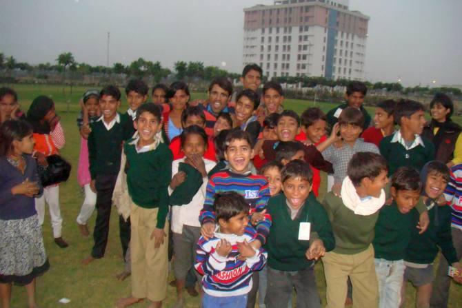 Om Prakash Gurjar playing with the children of migrant labourer's for whom he runs a school in the campus of Poornima University