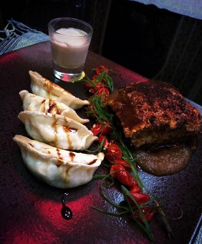 Apple puree and momos filled with truffle and a sauce in a shot glass at Go with the flow