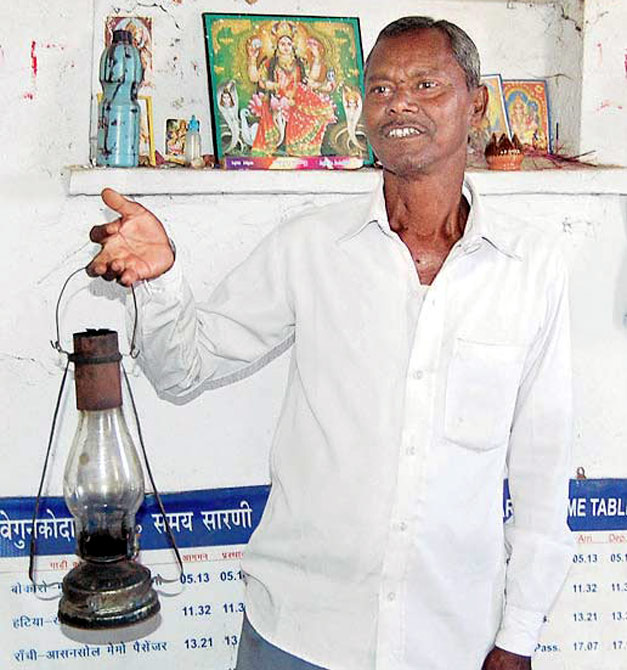 Dalu Mahato, a temporary ticket seller enters the station only after a daily puja