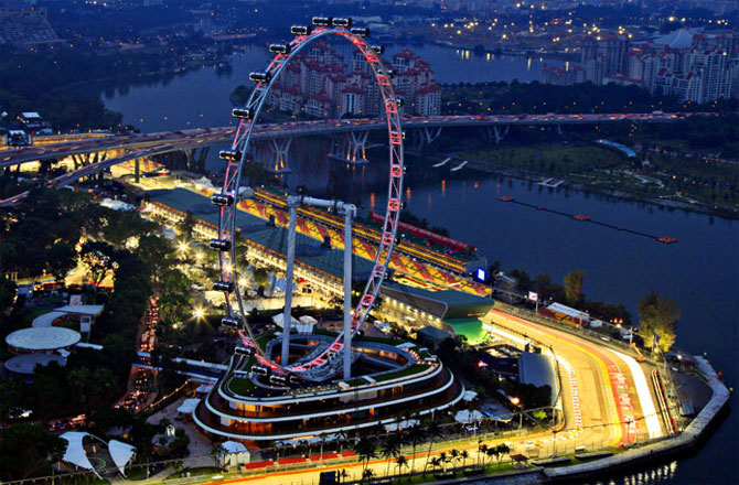 A part of the illuminated Marina Bay street circuit of the Singapore Formula One Grand Prix around the Singapore Flyer.